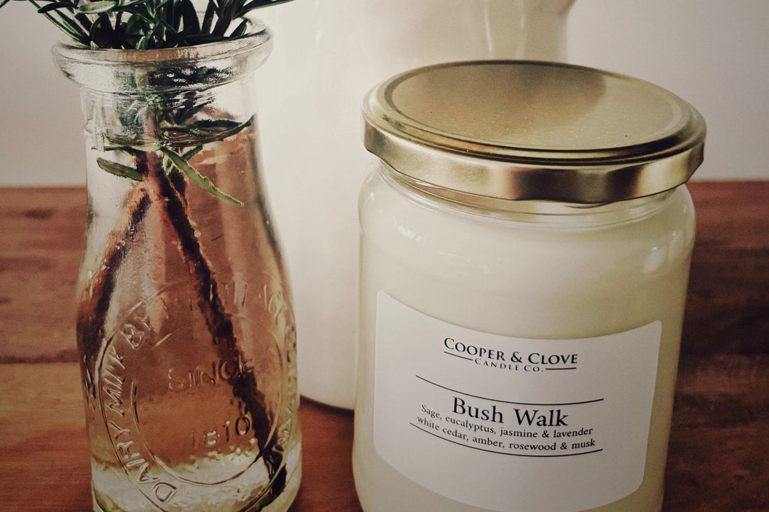 Best soy candles Australia: Bush Walk candle next to a glass vase with eucalyptus.